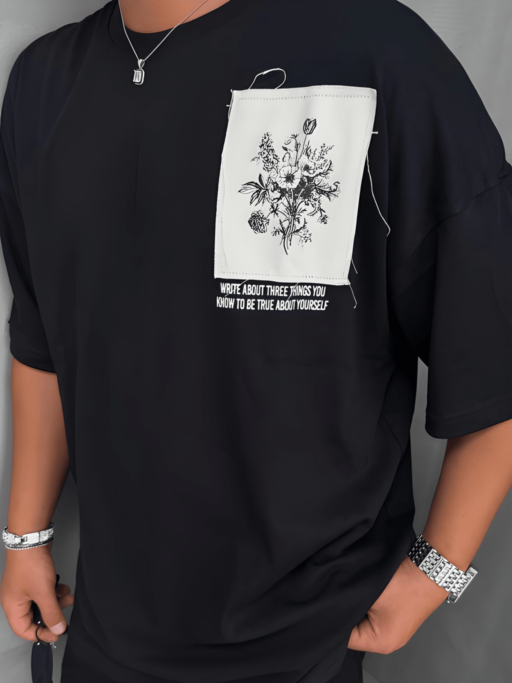 BLACK OVERSIZED T-SHIRT WITH A RED BANDANA AND FLORAL GRAPHIC